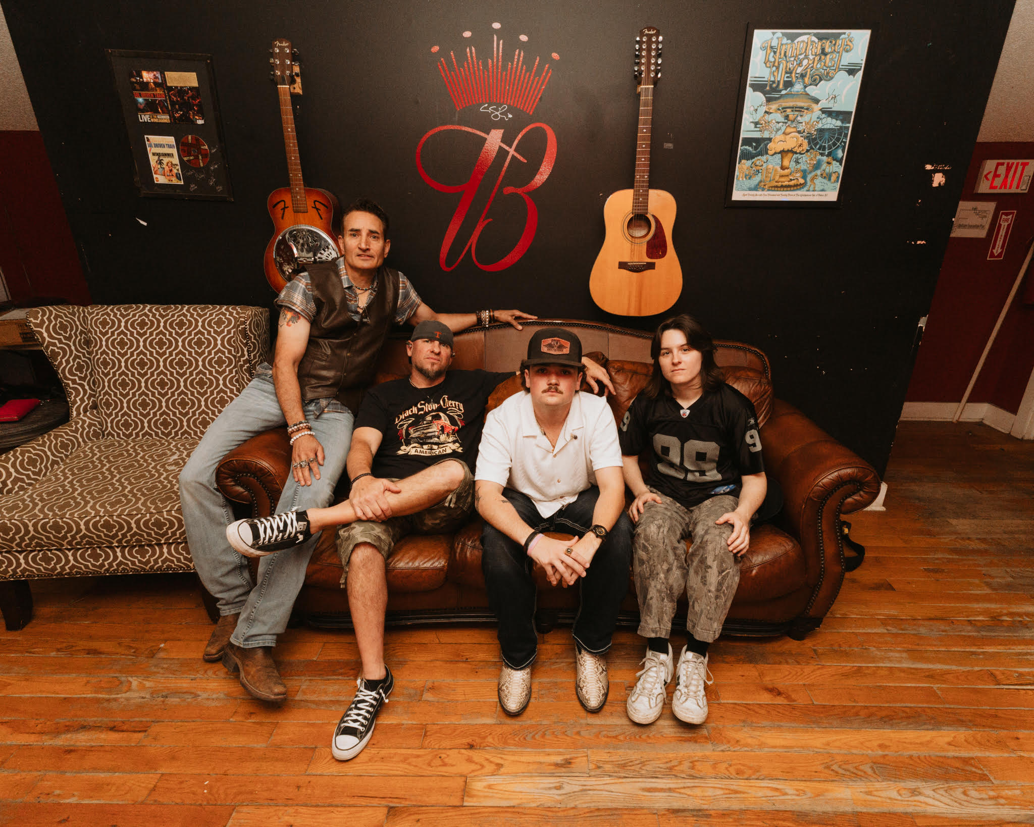 Tanner Beane and Dirty Power sit on a green room couch pre-show.